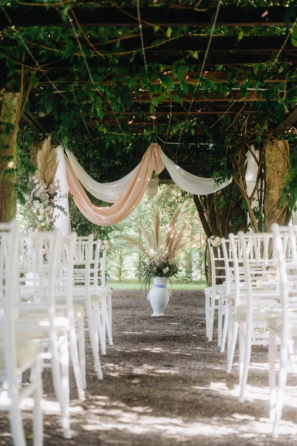 A ceremony pergola opening to Lake Como and the mountains