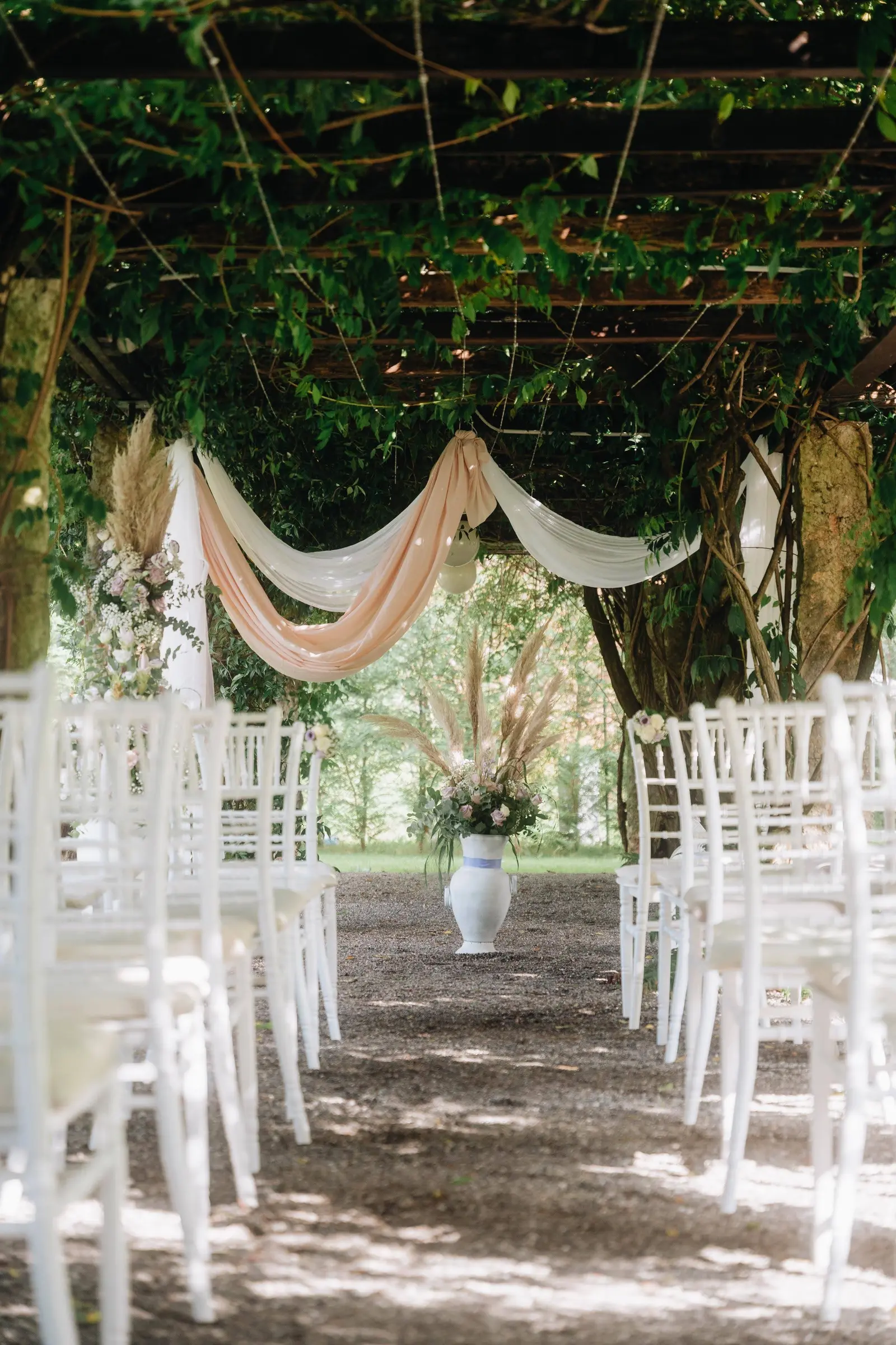 A ceremony pergola in a garden above Lake Como
