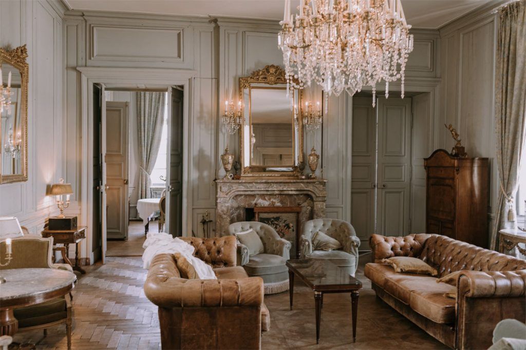 A château salon, chandeliers and old leather
