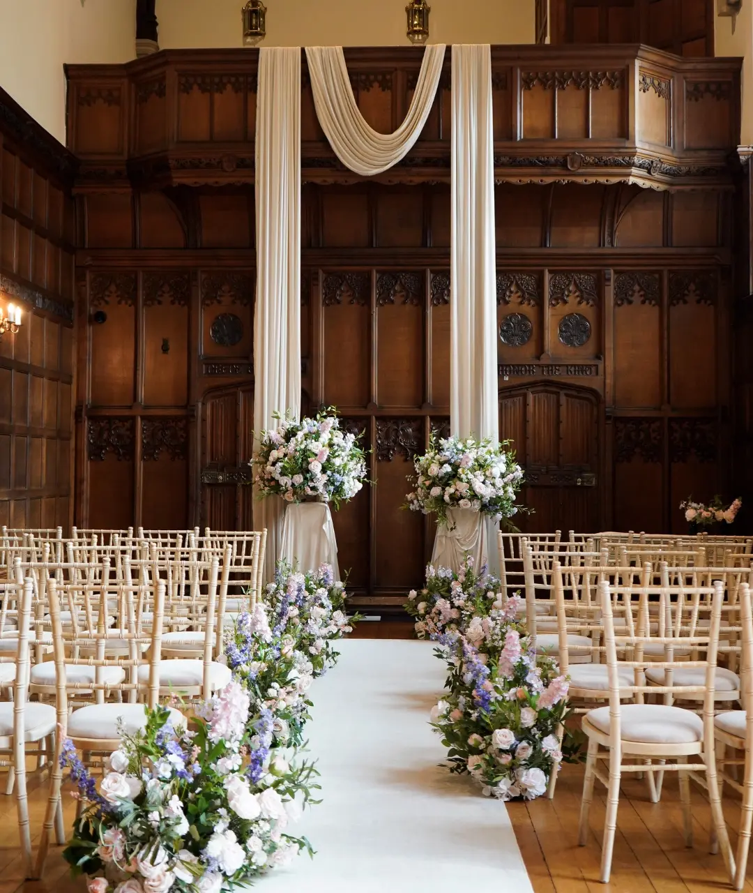 A bride reflected in a large gilt mirror in a panelled room