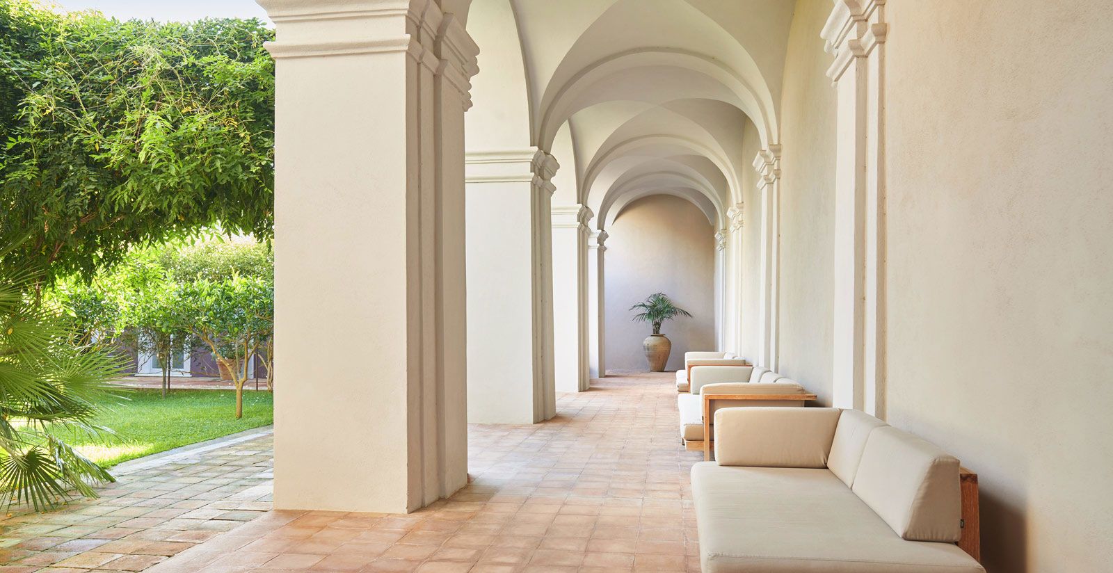 The whitewashed cloister colonnade of the former convent, Villa Paola, Tropea, Italy