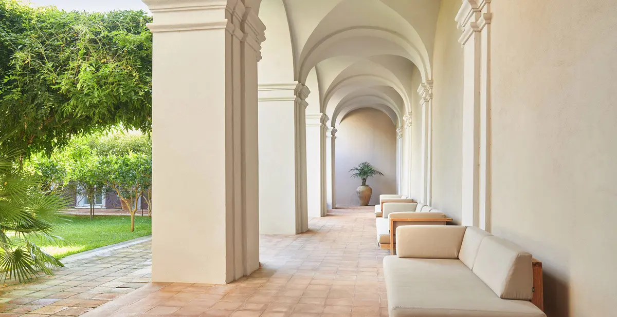 The whitewashed cloister colonnade of the former convent, Villa Paola, Tropea, Italy