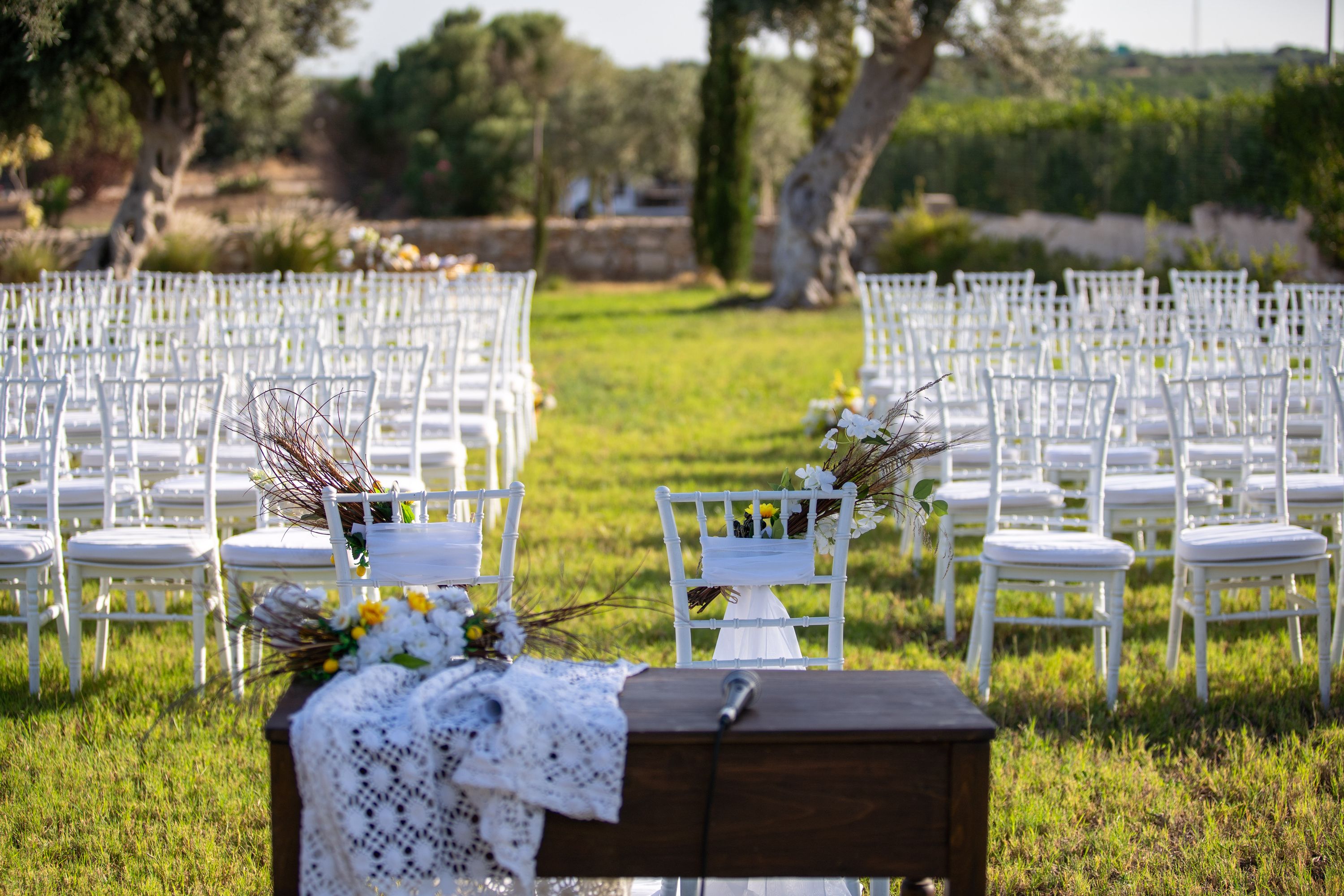 Chairs and a floral-dressed aisle table set for a ceremony