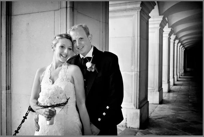 A bride and her father beneath the colonnade, Hampton Court Palace