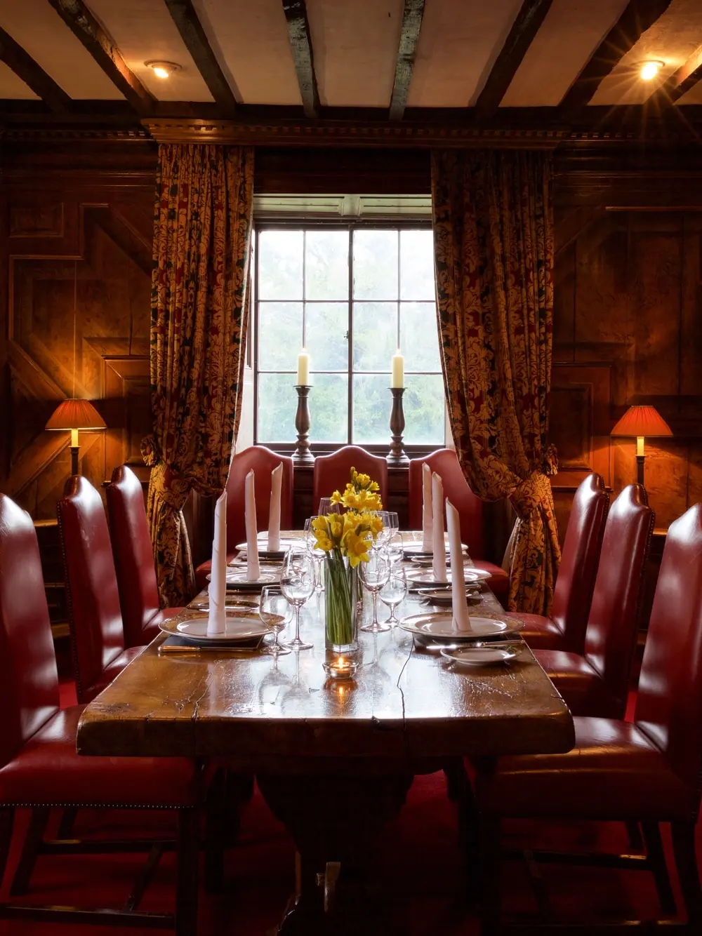 The King Charles I Room, an intimate wood-panelled dining room with a candlelit table