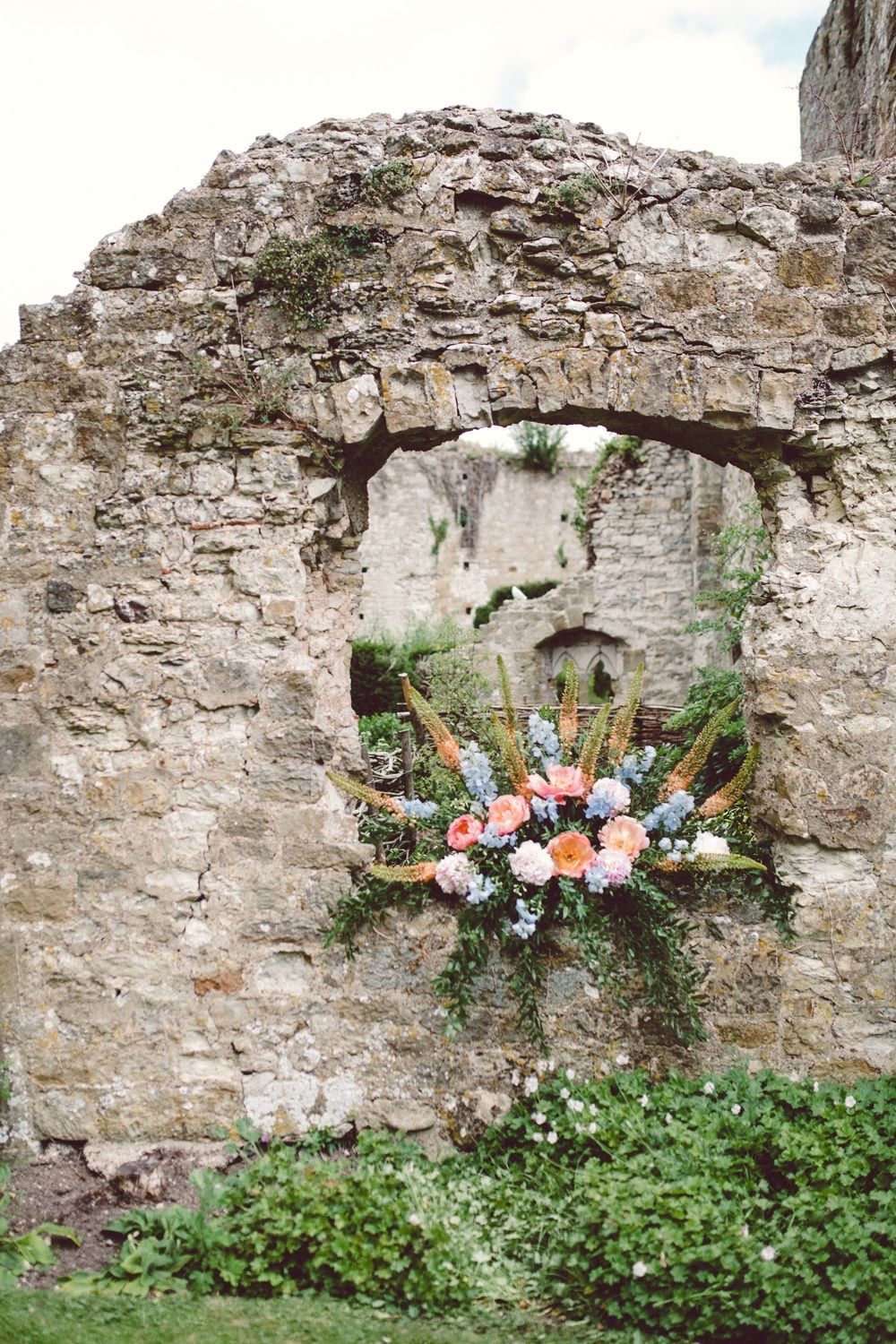 A floral arrangement set into a ruined stone wall of the castle