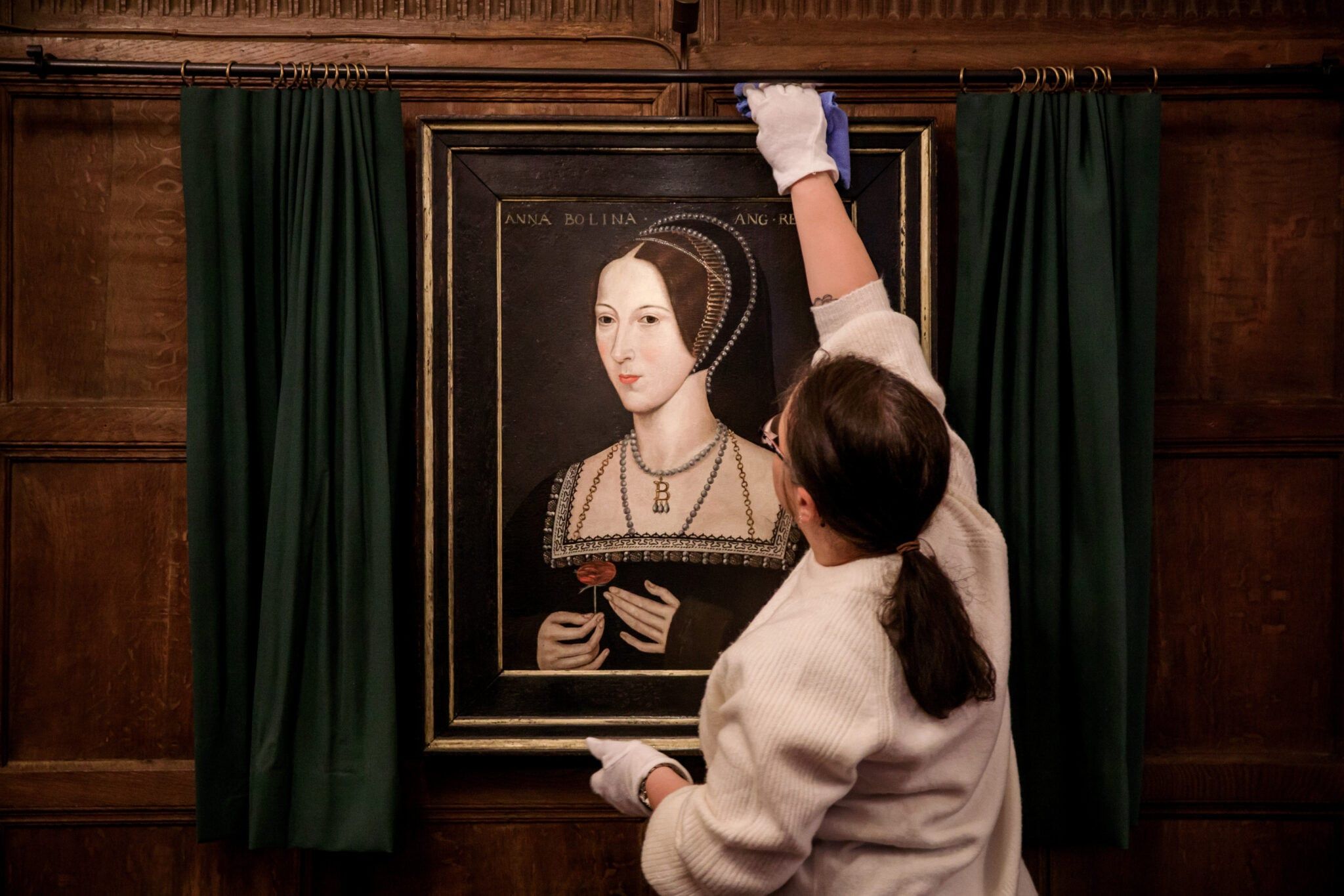A Tudor portrait of Anne Boleyn displayed in a dark-panelled room at the castle