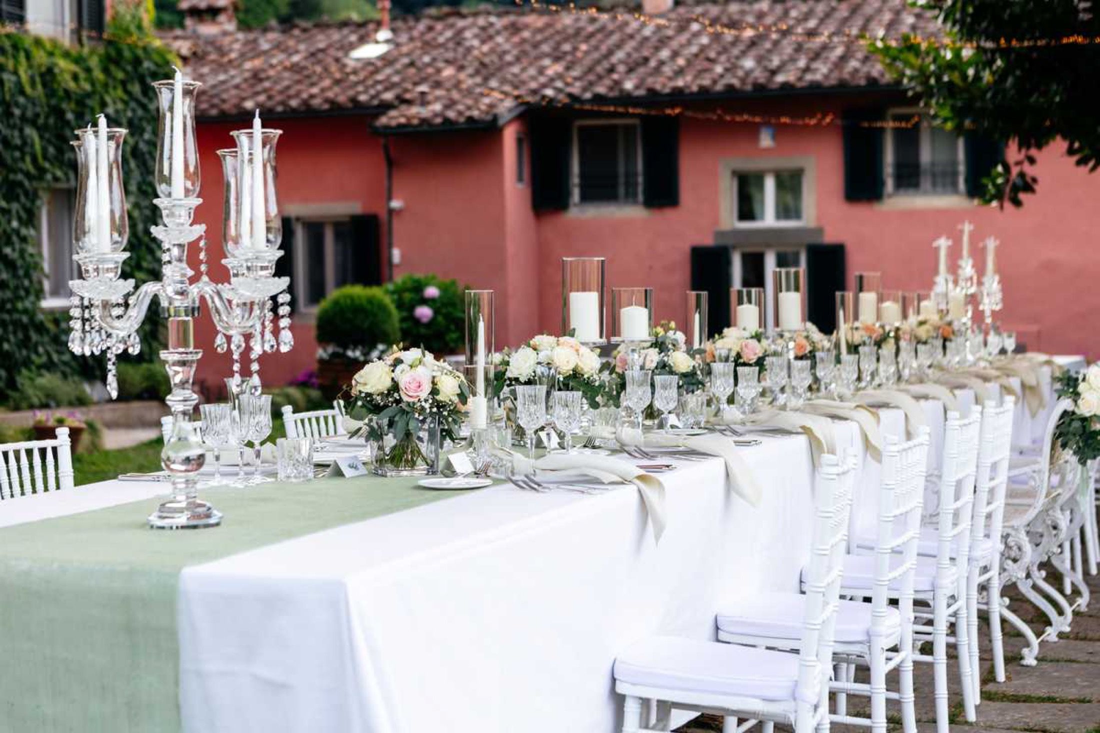 A candlelit banquet table set before the villa, Burlamacchi Villas, Bagni di Lucca, Italy