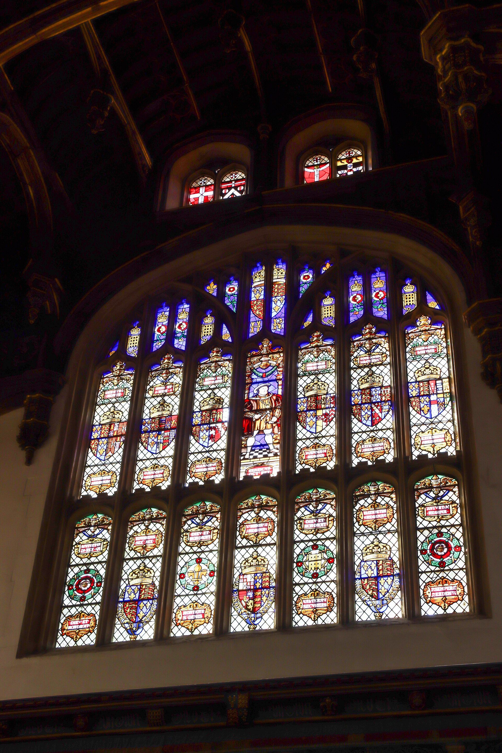The Great Hall's soaring stained-glass window, heraldic glass set in dark timber
