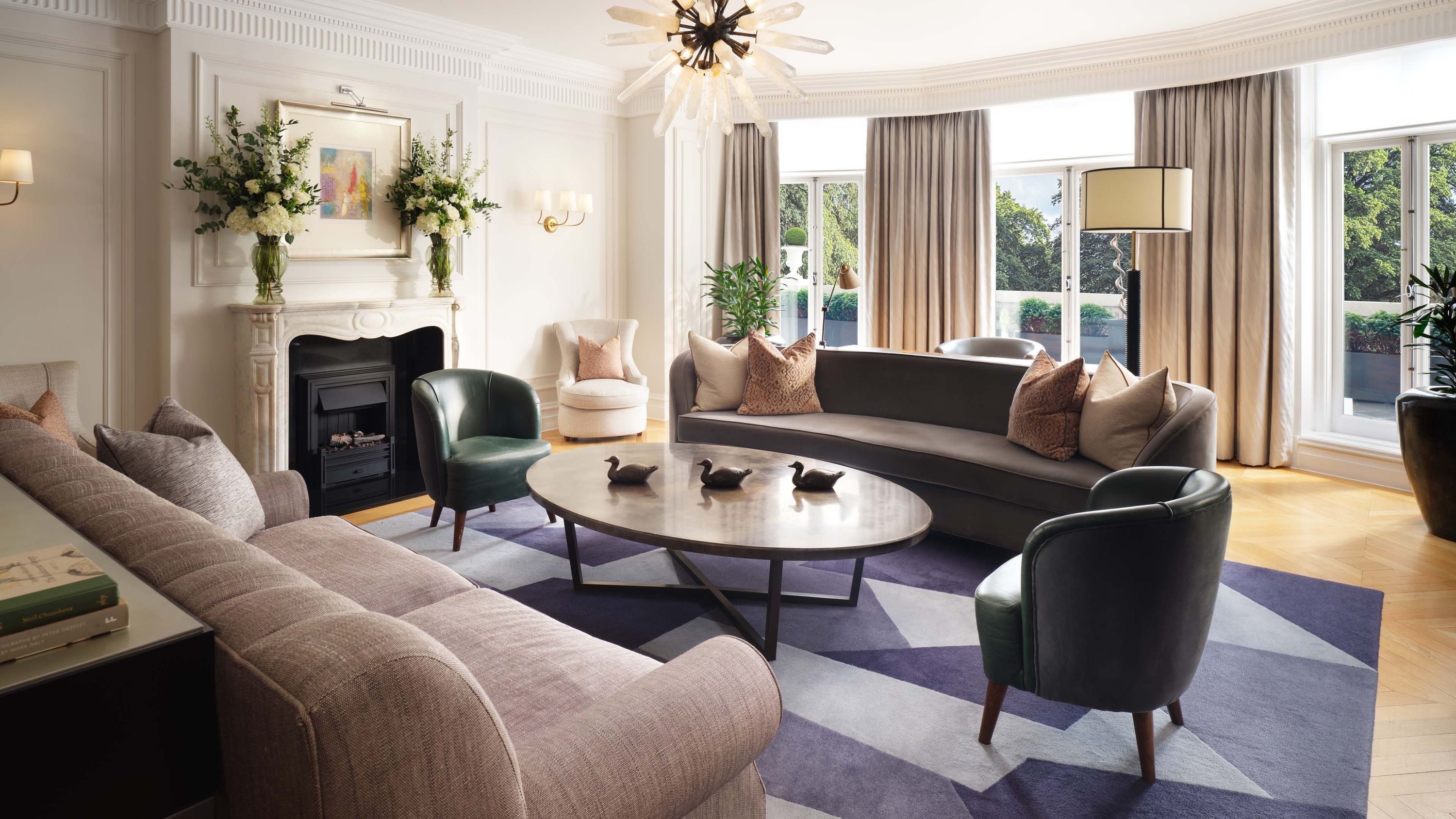 Suite sitting room with fireplace and park windows