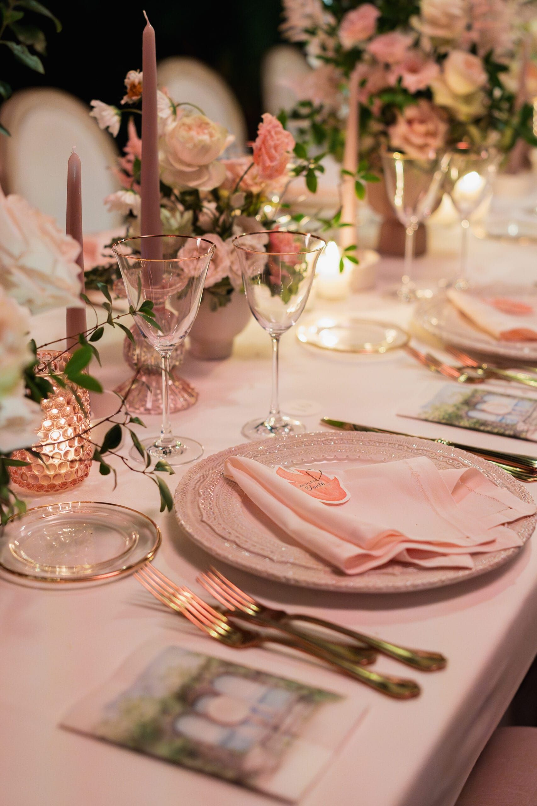 A place setting in blush: pink tapers, garden roses, gold cutlery
