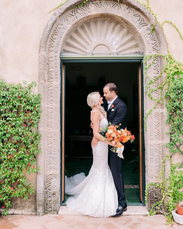 The couple in a stone archway doorway