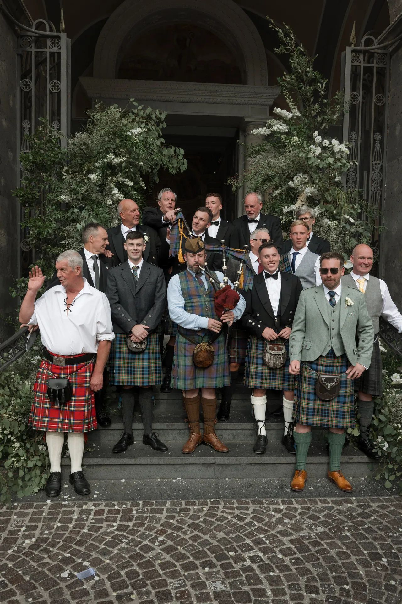 The men on the steps, six of them in kilts