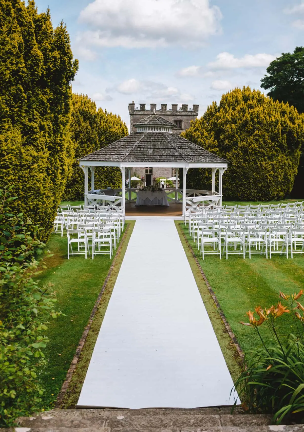 The garden Bandstand set for an outdoor ceremony, a turret behind