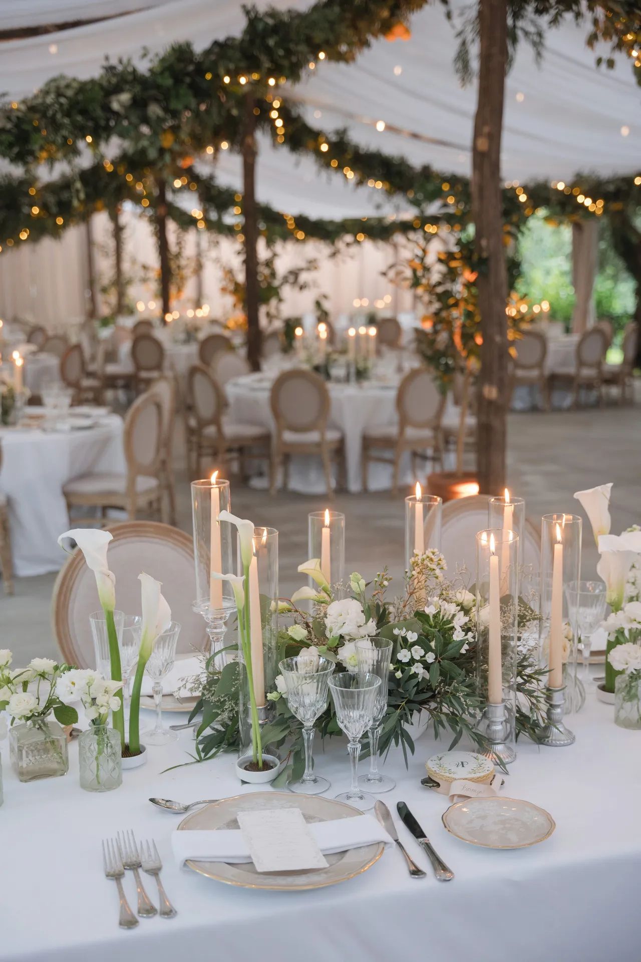 The marquee after dark, calla lilies and tapers at every cover