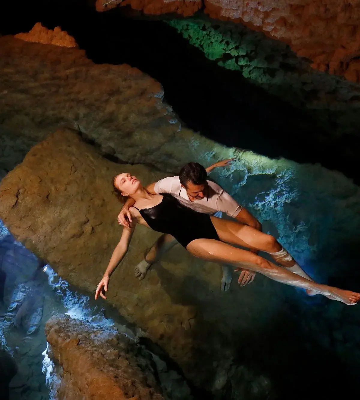 The Inferno chamber of the thermal grotto at Grotta Giusti, stalactites lit in warm tones