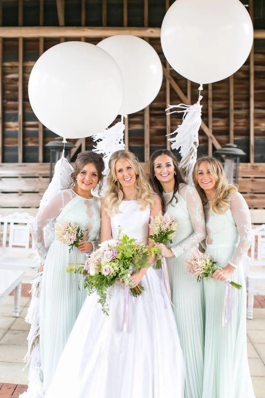 Bridesmaids in sage green, white balloons, Gaynes Park