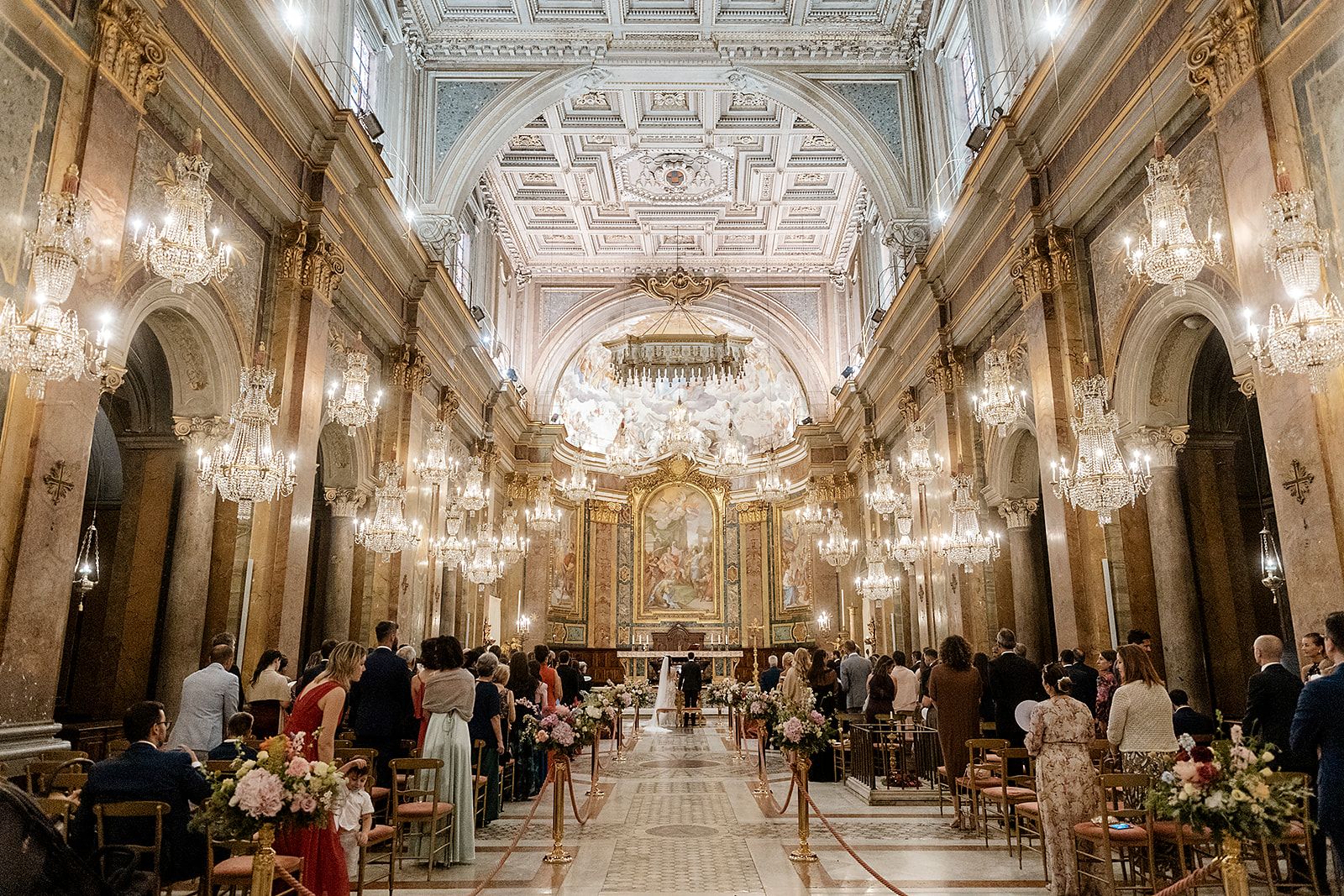 A ceremony beneath rows of crystal chandeliers, Basilica dei Santi Giovanni e Paolo, Rome