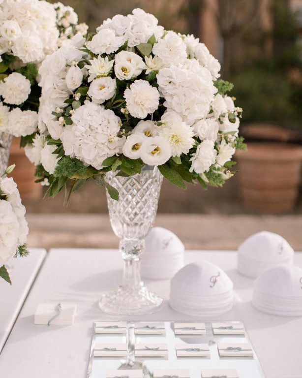 A reception table dressed in white, glass and crystal