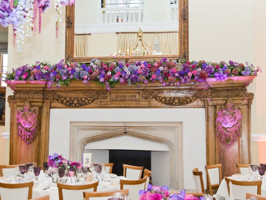 A floral installation dresses the fireplace mantel, Farnham Castle