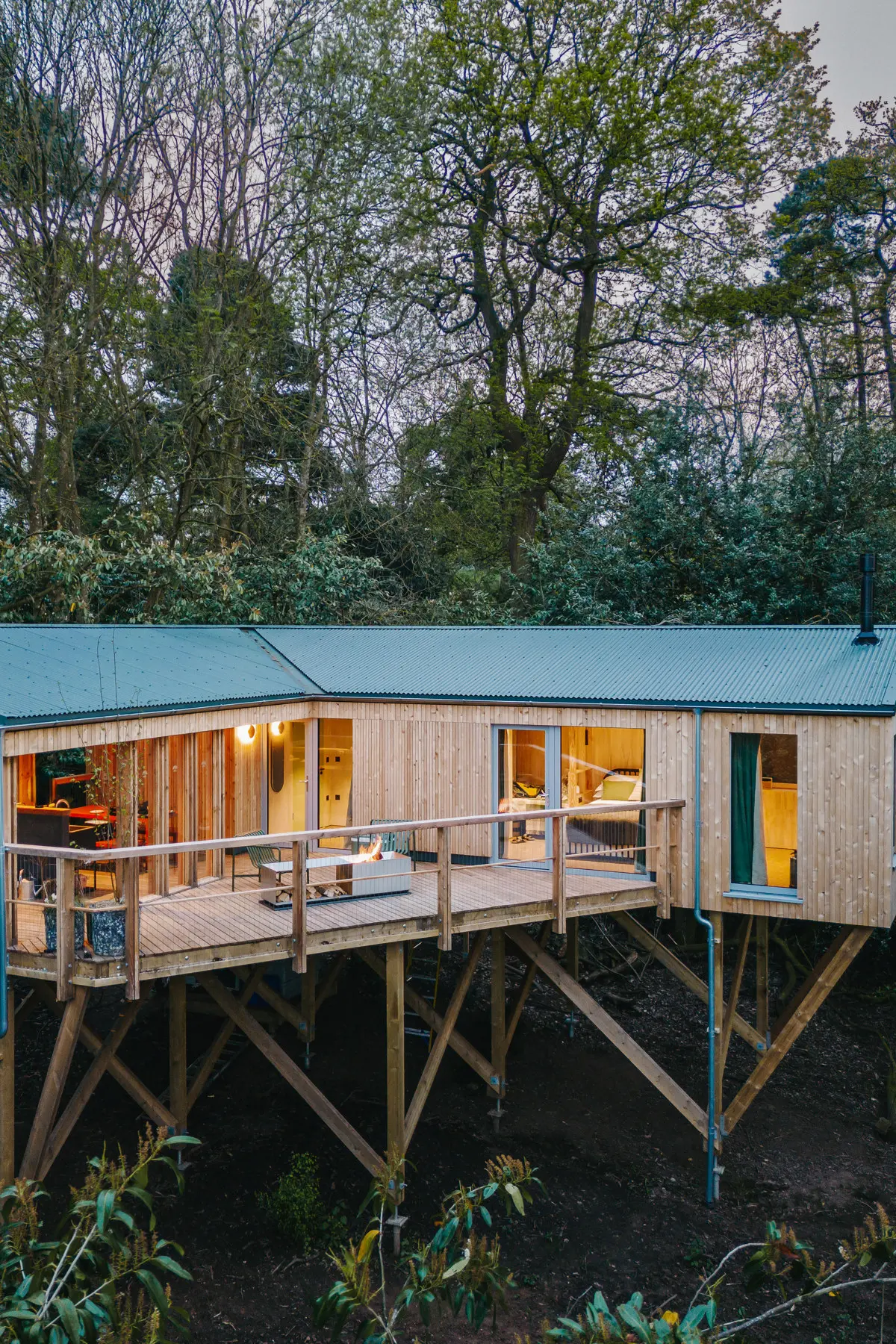 A timber treehouse raised among the trees on the estate