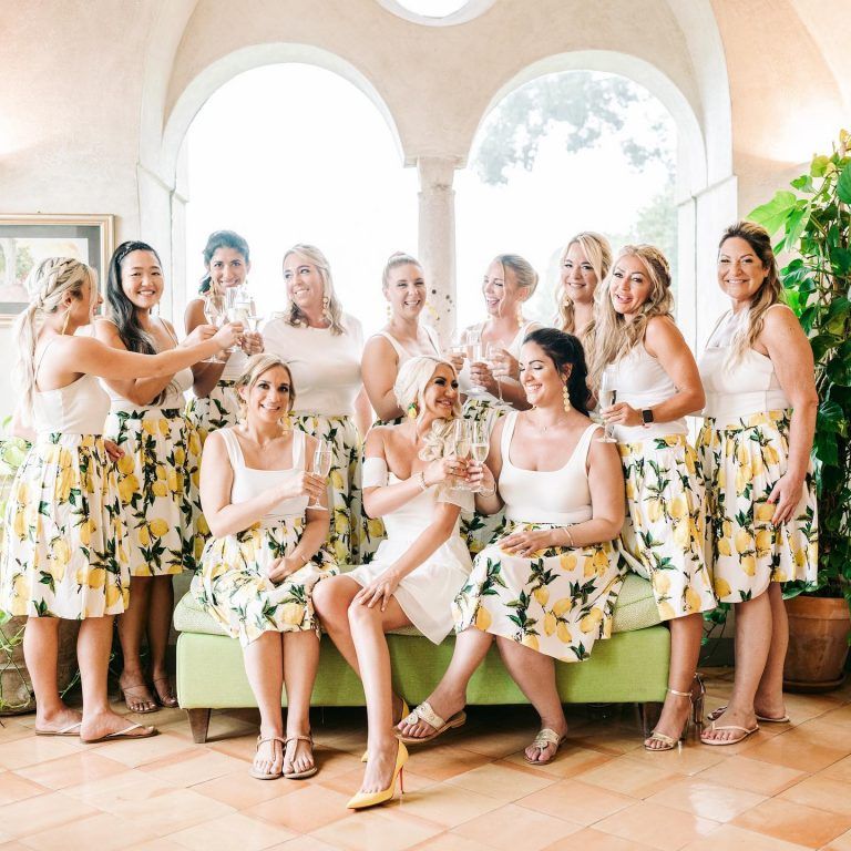 The bridal party toasting in lemon-print dresses
