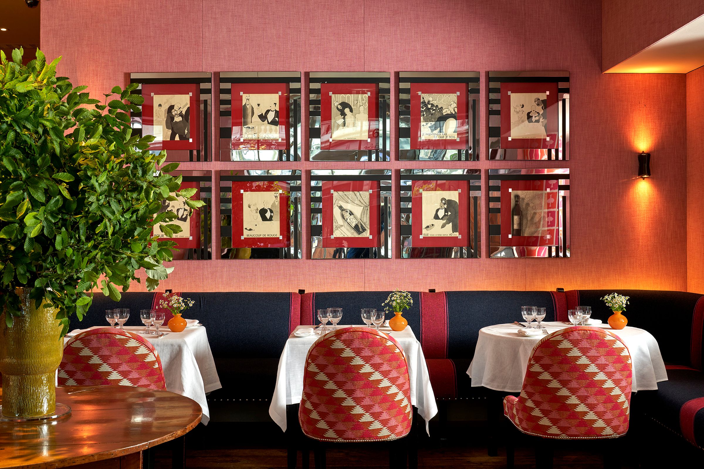 Brumus, dining tables beneath colourful artwork