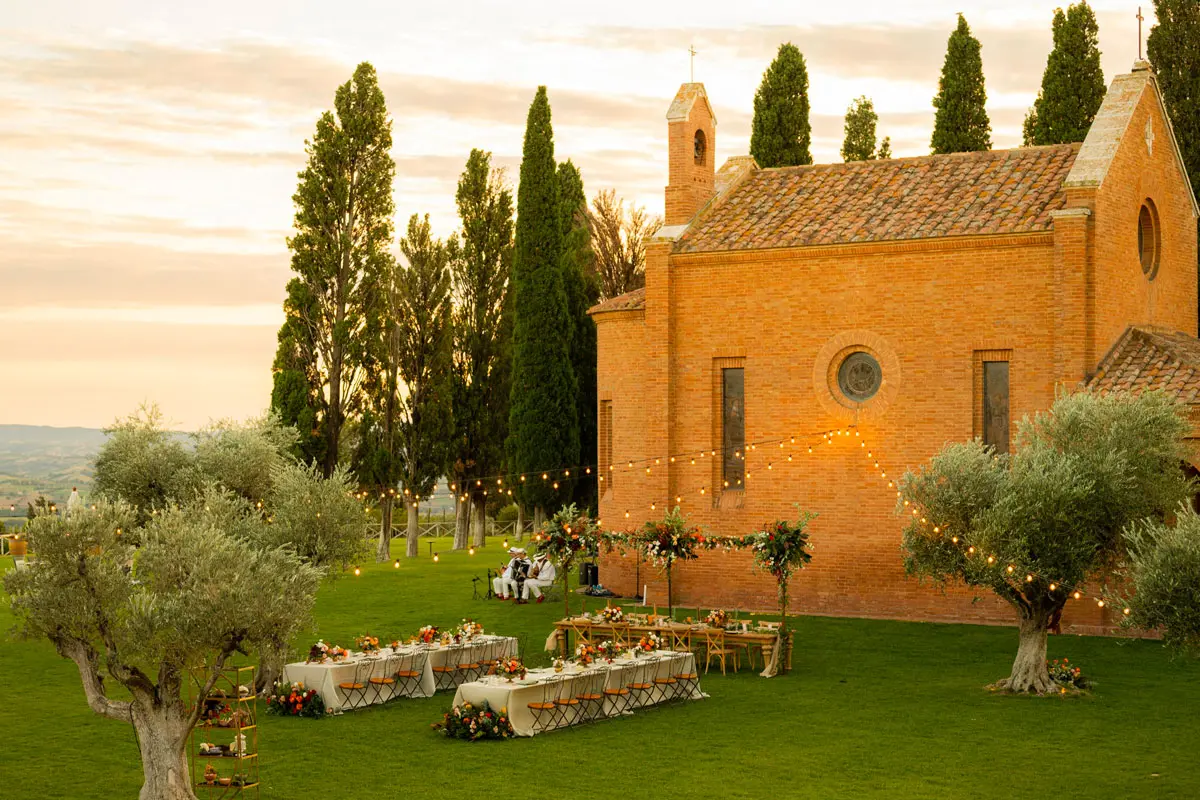 The stone cortile at ColleMassari set for a wedding dinner