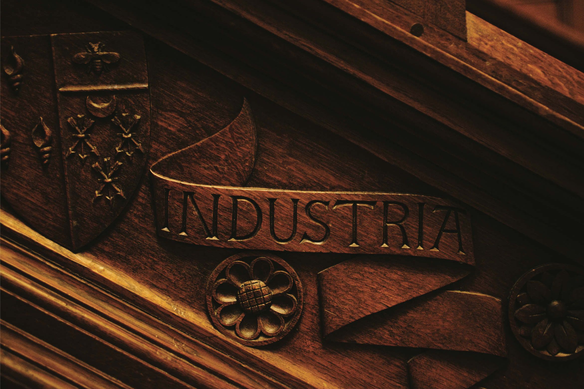 A carved crest reading INDUSTRIA, the Peel family motto, in the house