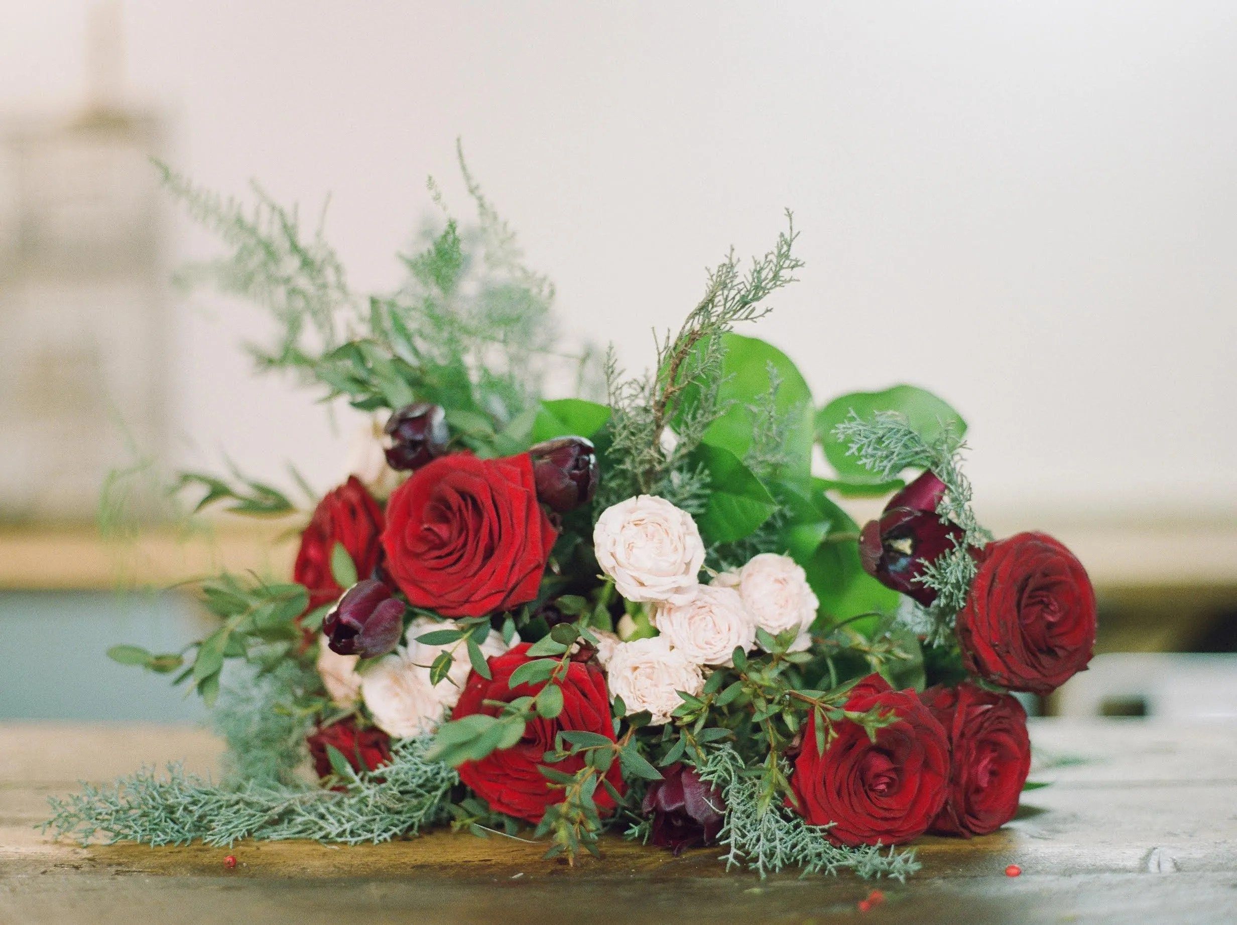 A seasonal arrangement of red and white roses