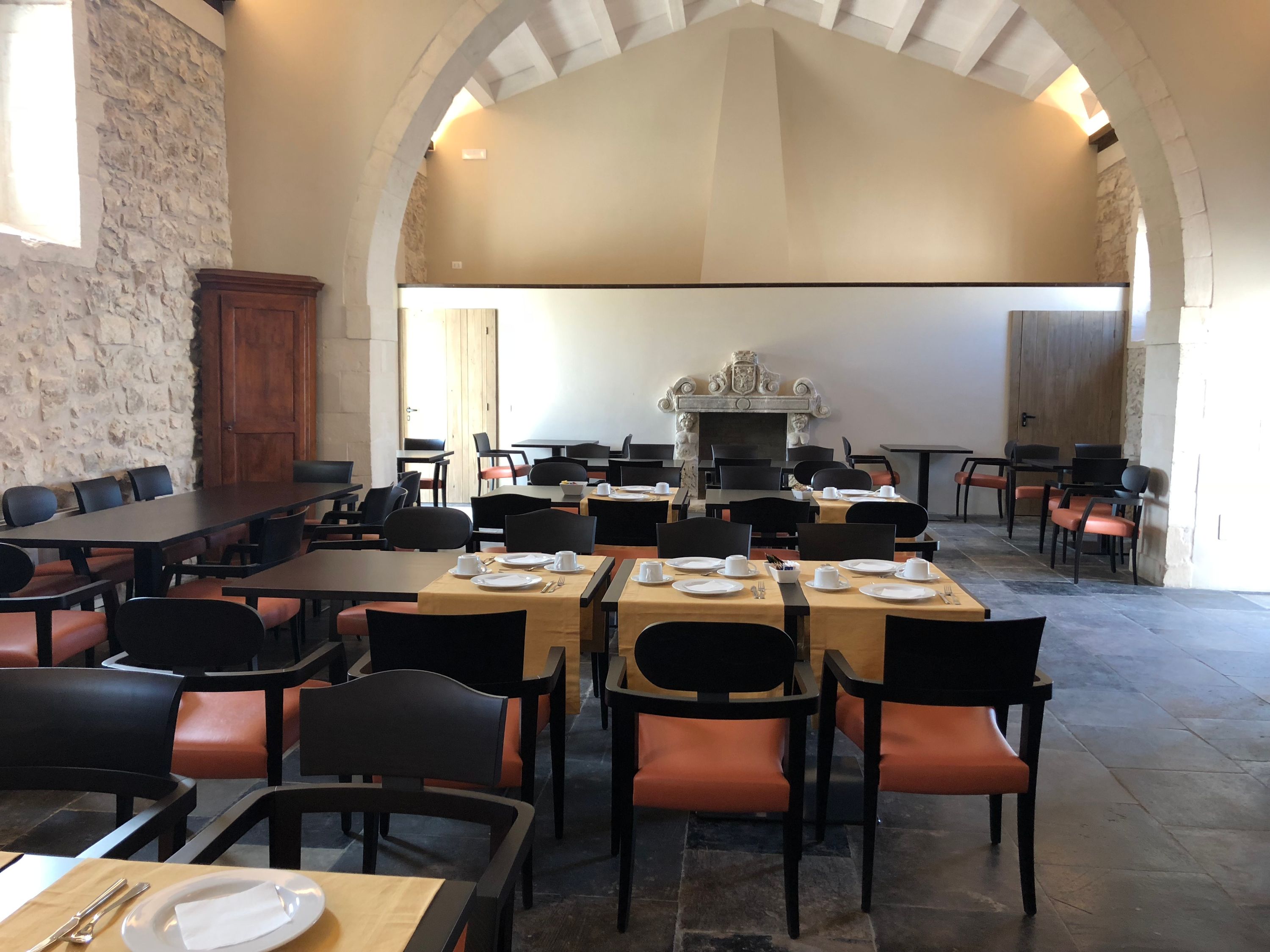 Breakfast service laid across the dining room's long tables