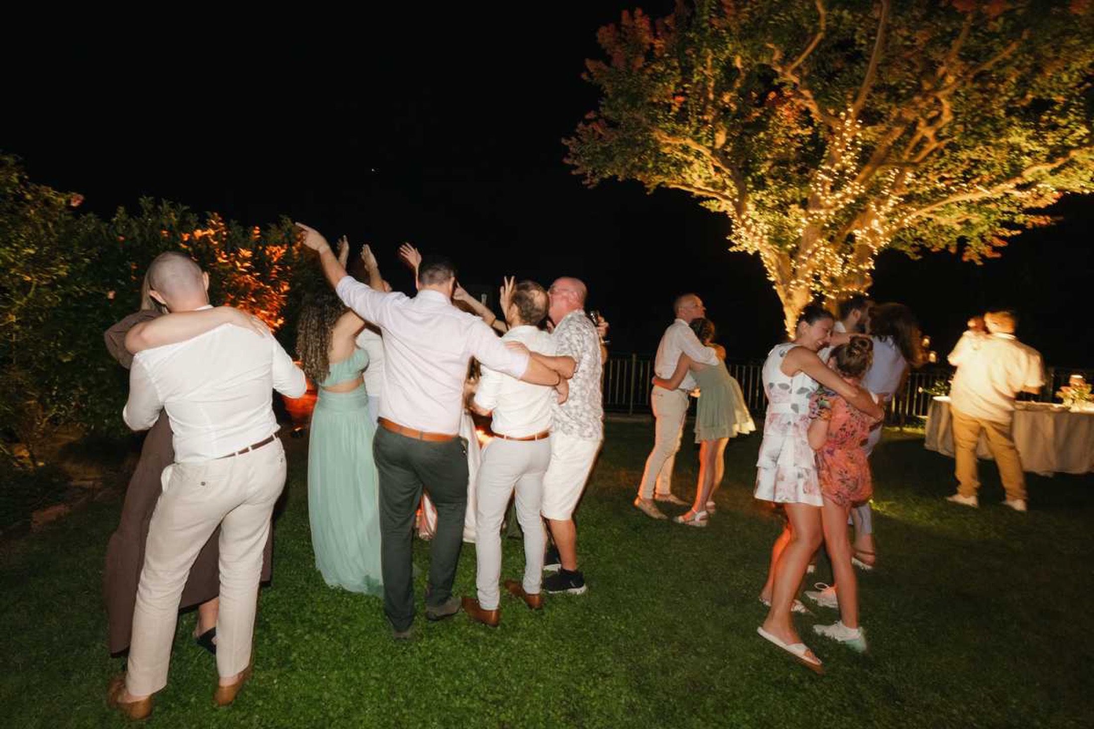 Dancing under the lit trees