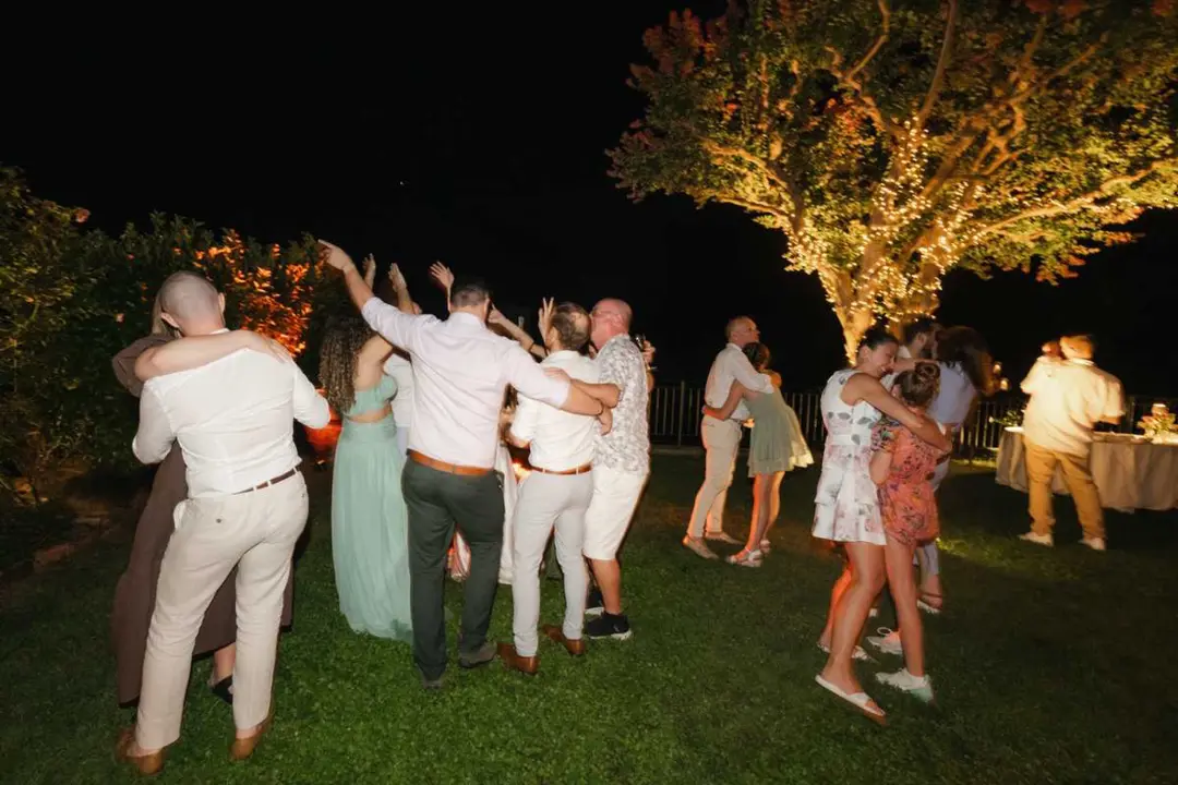 Dancing under the lit trees