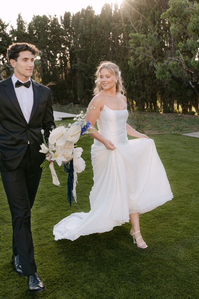 Couple walking through the grounds at sunset