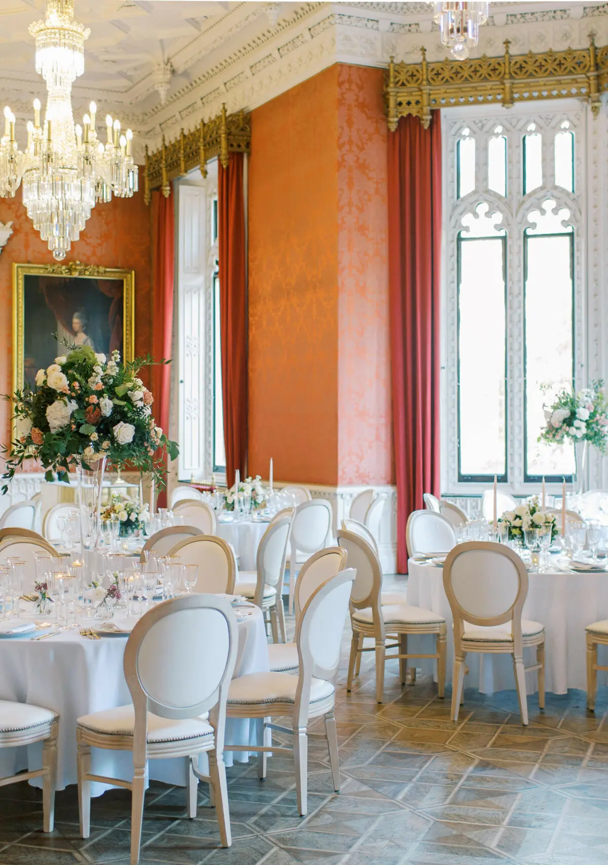 The Waldegrave Suite laid for a wedding breakfast beneath chandeliers