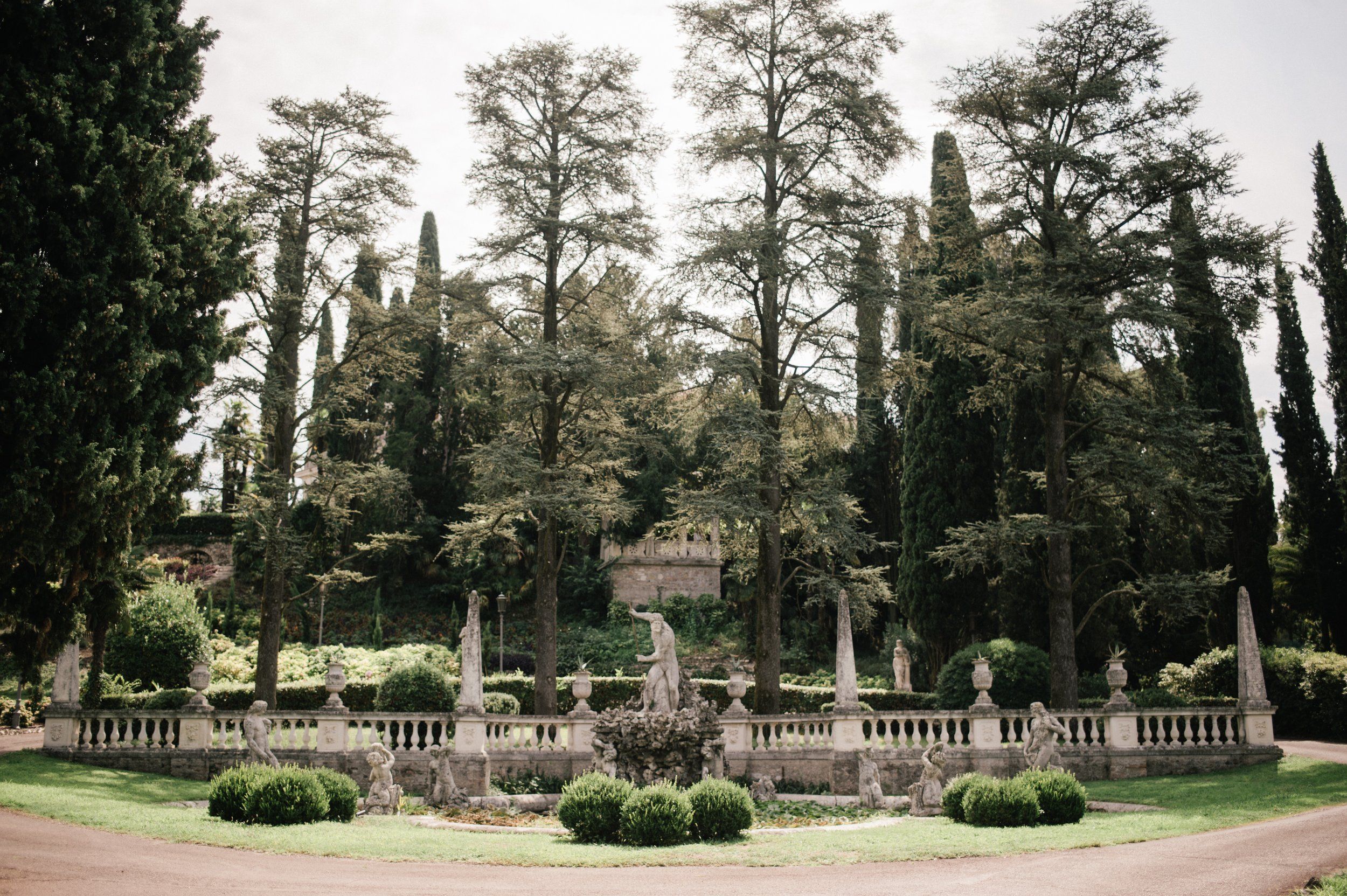 A formal Italianate garden at Isola del Garda, balustrades and classical statuary among cypress and pine