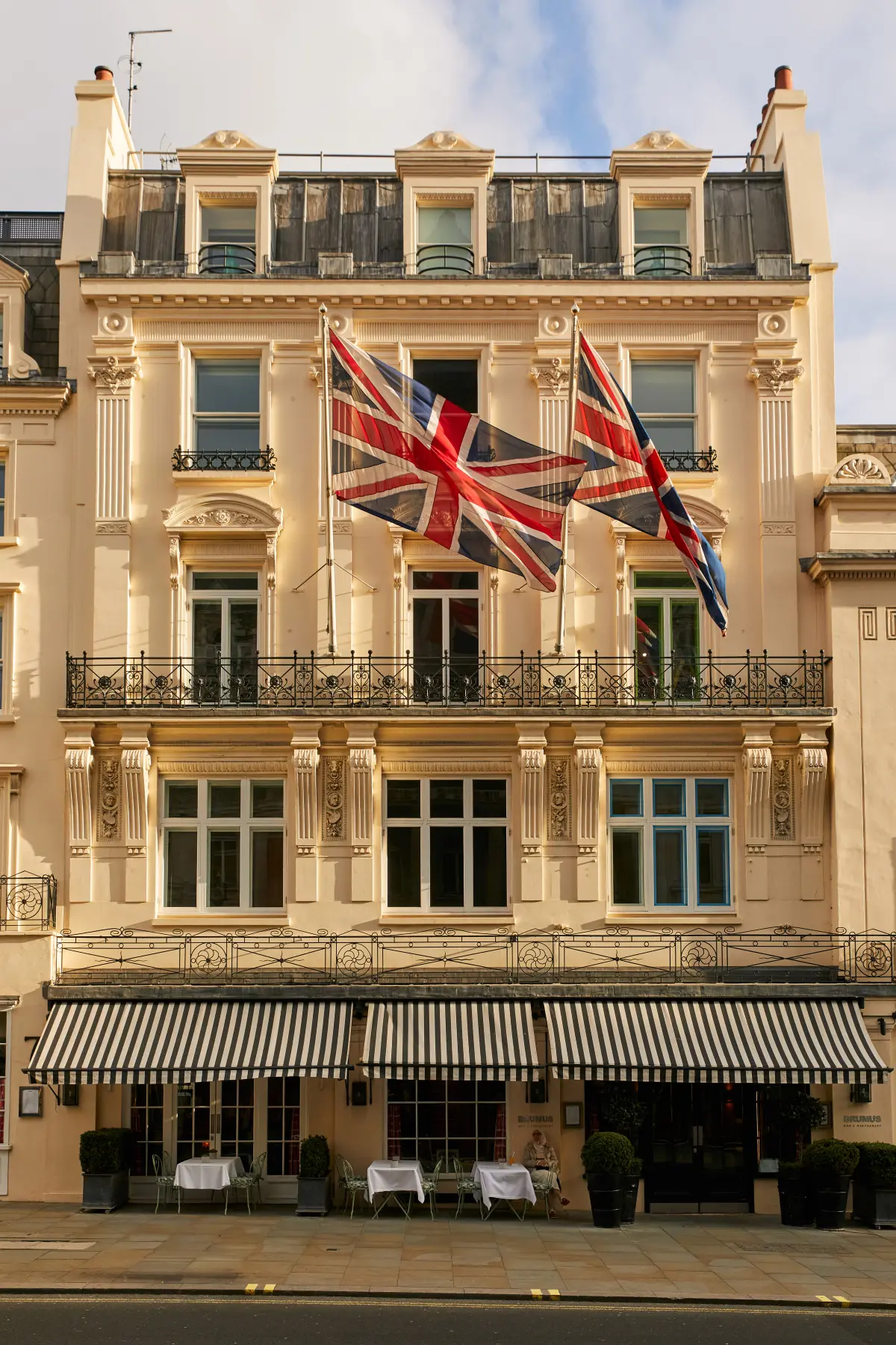 The Regency facade off Haymarket, with awning and Union Jack in the West End, Haymarket Hotel, London, England