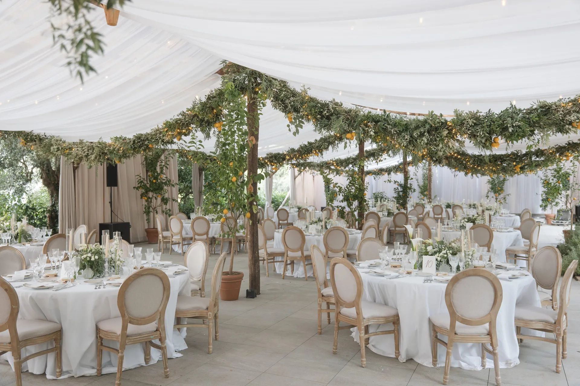 A marquee dressed with citrus and greenery garlands