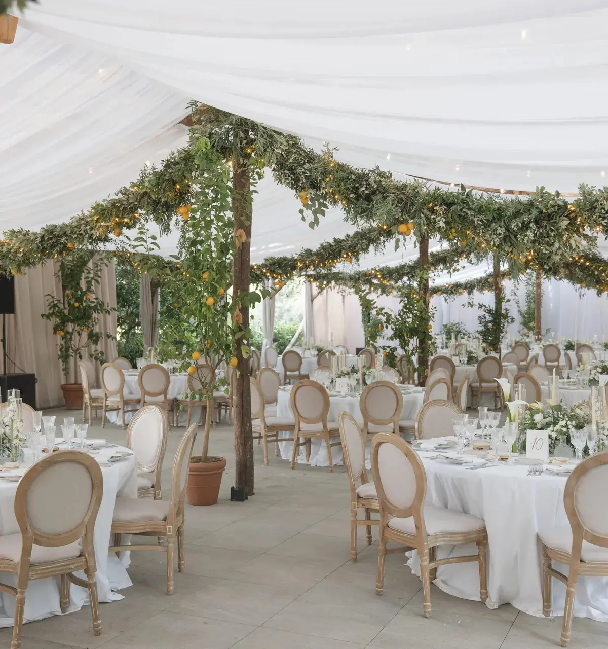 A wedding marquee dressed with citrus and greenery garlands