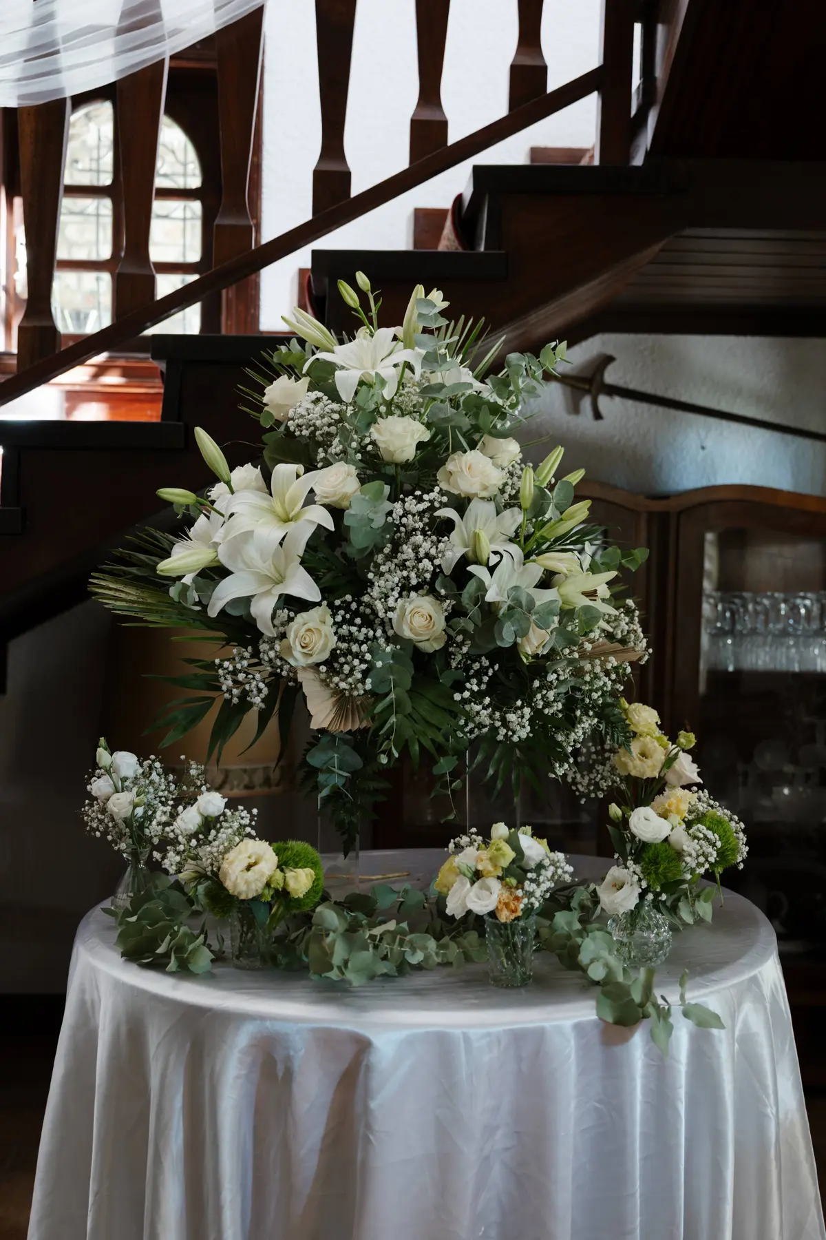 White flowers arranged by a villa staircase