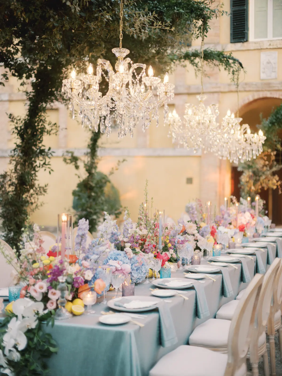 Candlelit dinner under a chandelier hung from the trees, wildflowers and whole lemons down the table, La Foce