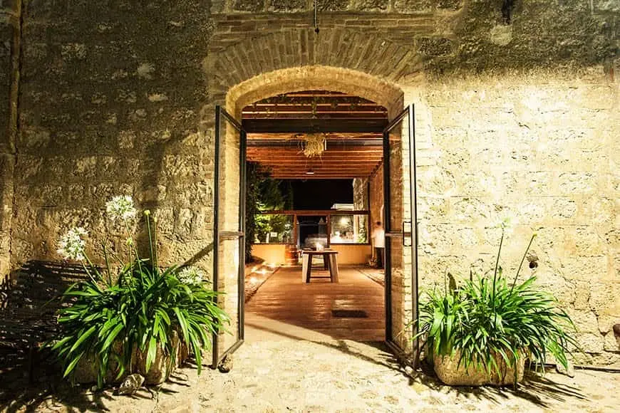The arched doorway into the vaulted Il Granaio at night