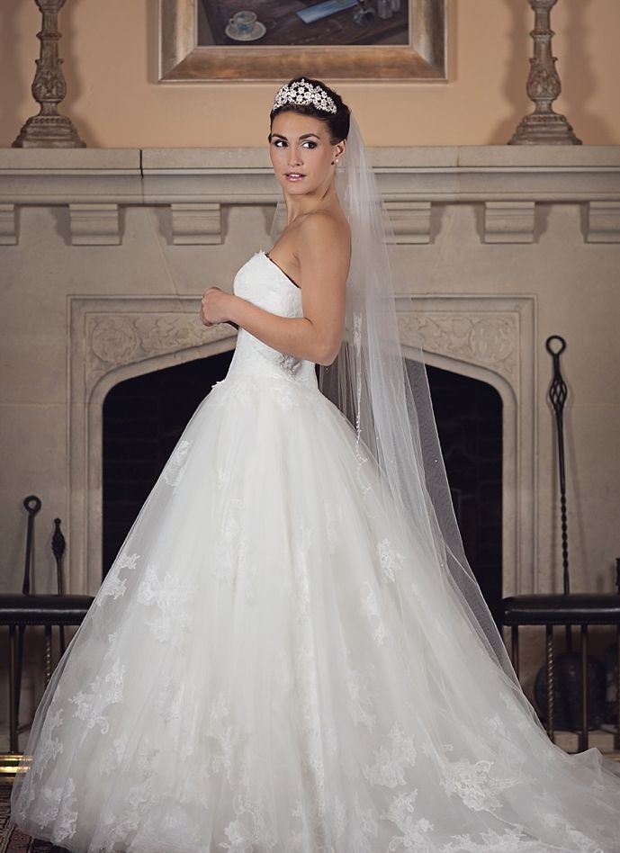 A bridal portrait beside a fireplace, lace gown and cathedral veil, Nadine Pyke Make Up Artist, Surrey, England