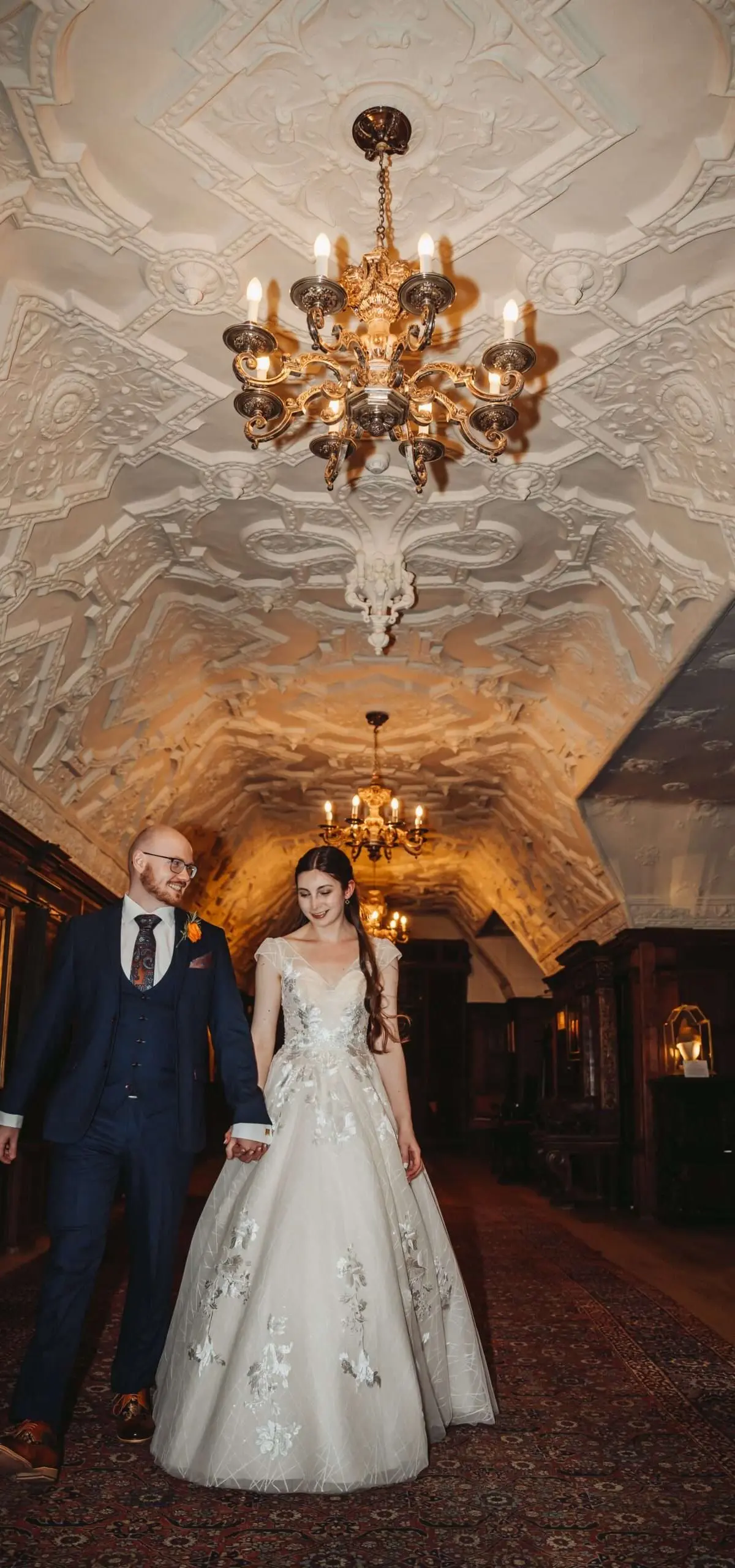 A long banqueting table beneath portraits in the castle Dining Hall