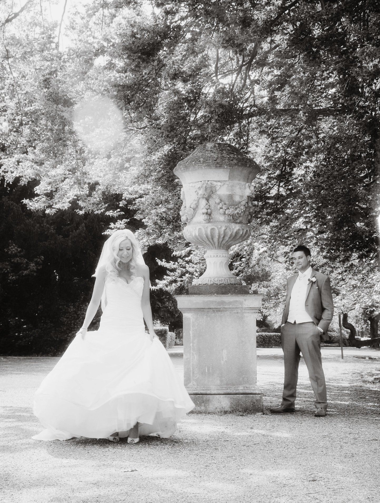 A bride and groom in the gardens at Oatlands Park Hotel, Surrey
