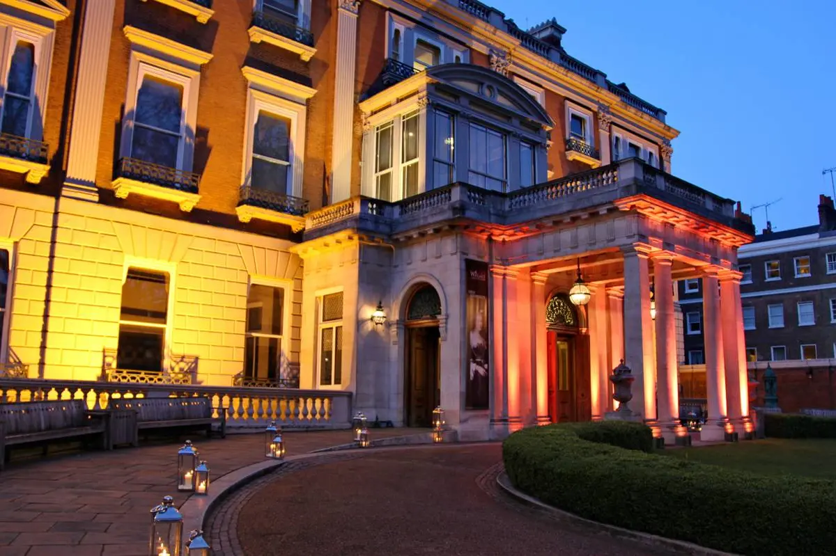 Hertford House at dusk, the facade and portico washed in amber light