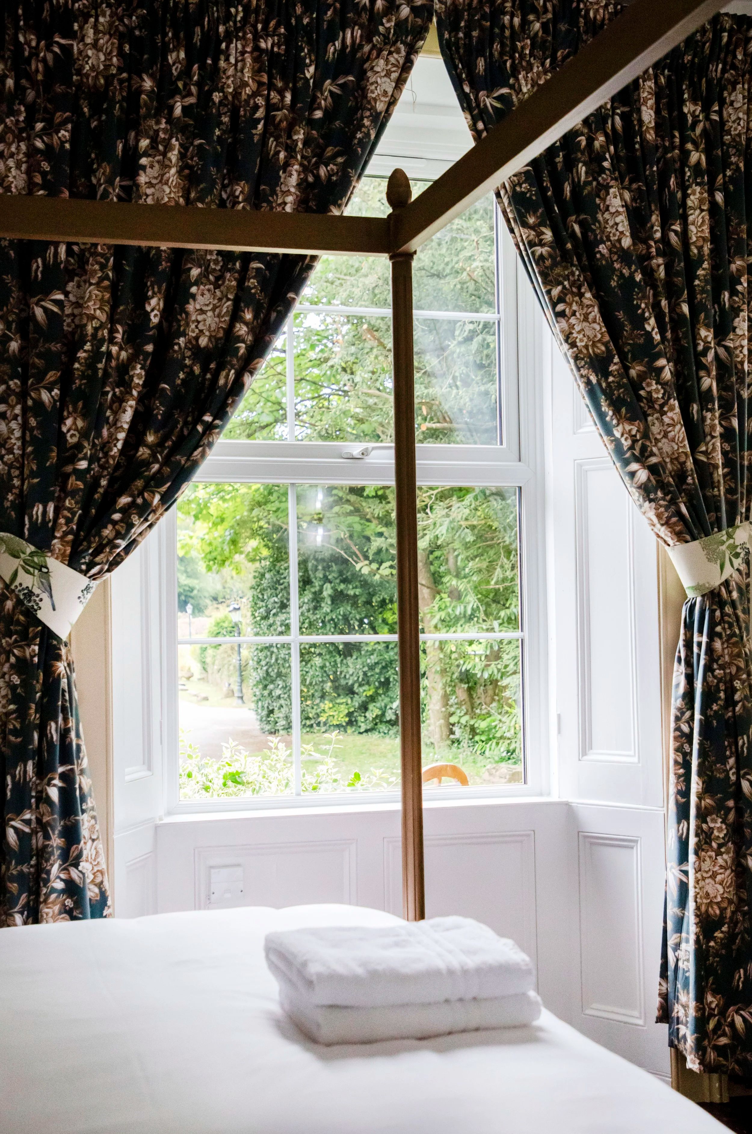 A bedroom bay window with countryside views