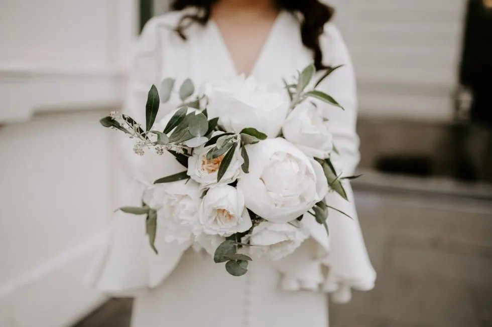 Getting ready, a white and green bouquet in hand, The Lanesborough