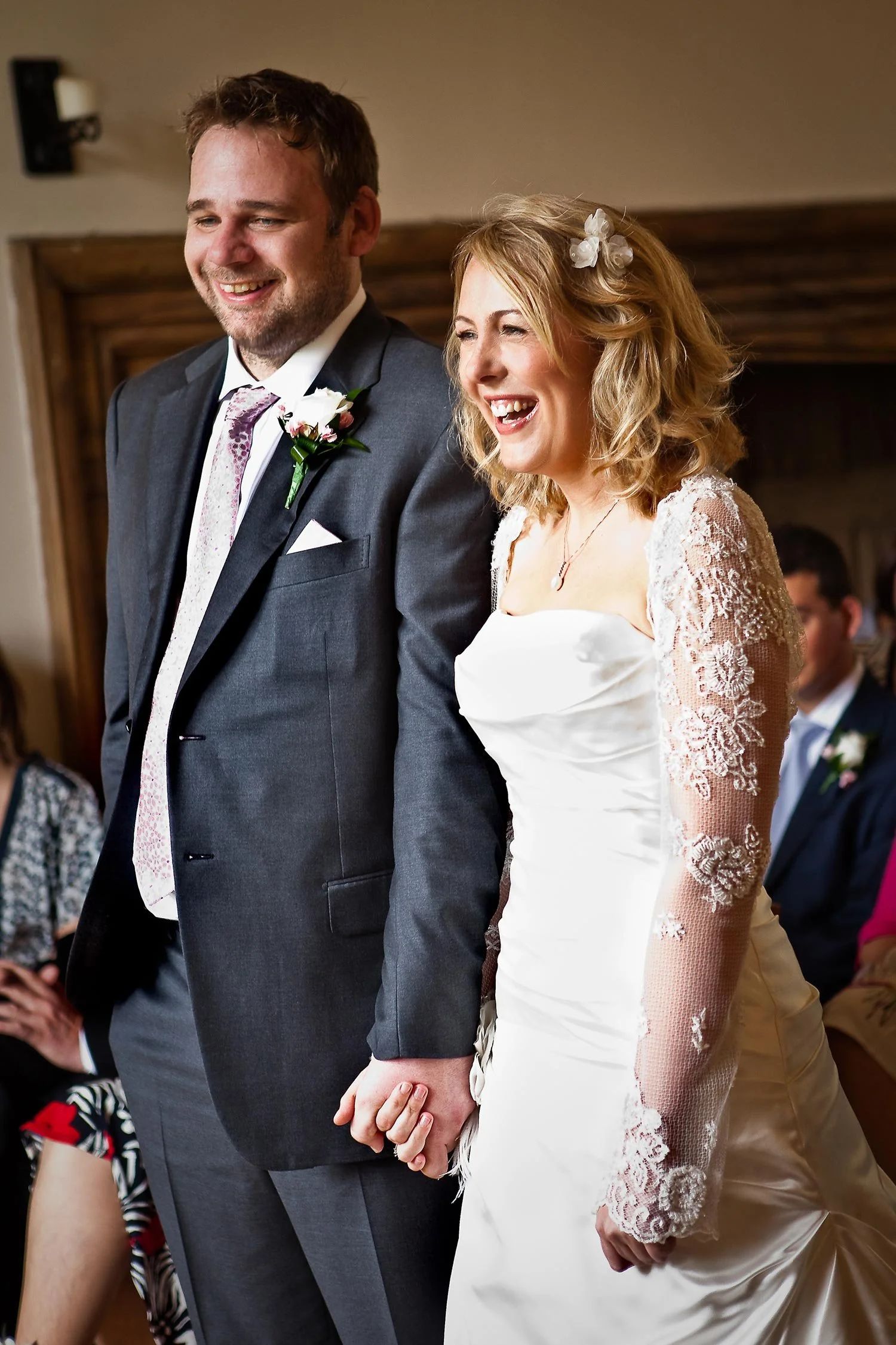 A bride and groom laughing together during their ceremony, Notley Abbey
