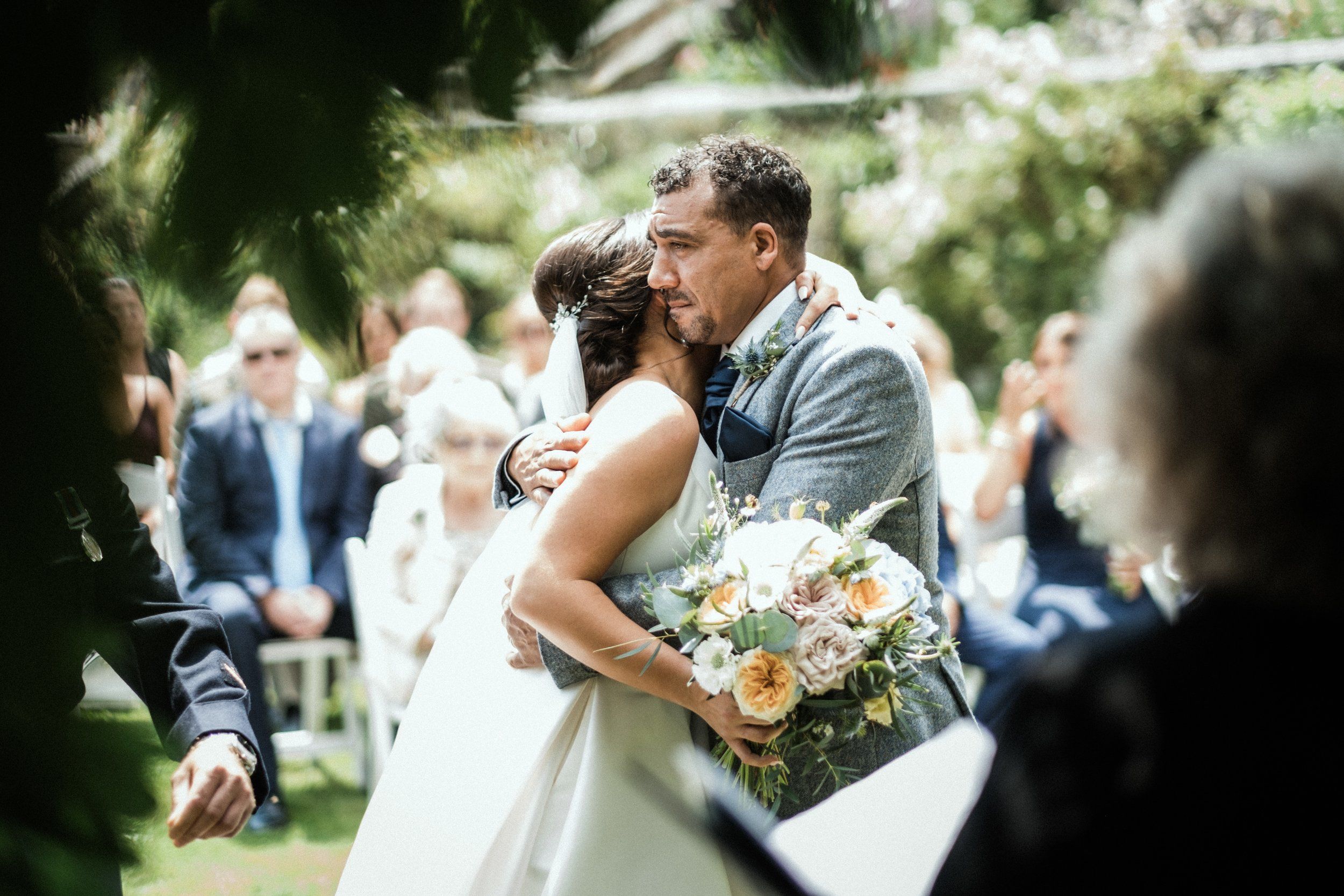 A ceremony embrace, the couple among their guests
